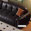 Causeuse-coussin modulable noire en cuir véritable