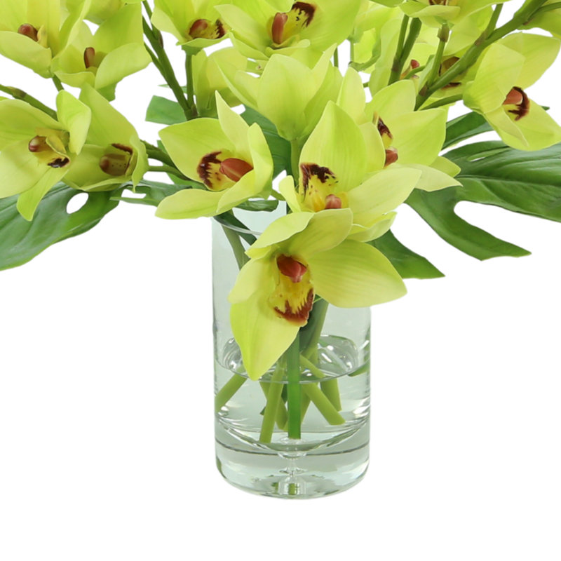 Orchids And Leaves In A Glass Vase
