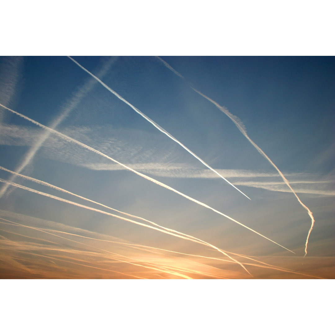 A Lot Of Vapor Trails During Sunset von Alfsky - No Frame Kunstdrucke auf Leinwand