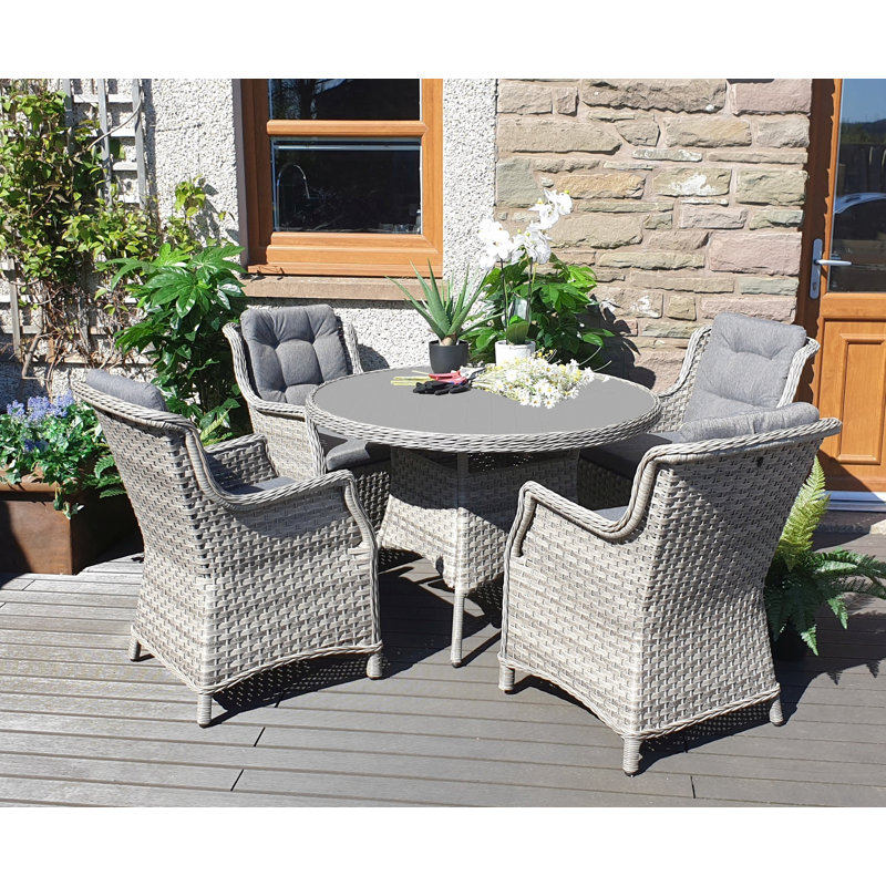Metairie 4 - Person Wicker Patio Dining Set with Round Table , Cushions Included