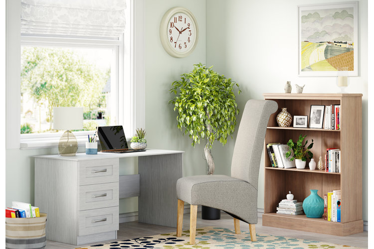 modern office with accent chair, desk, and table lamp