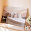 Toile, intérieur de chambre à coucher serein, art mural orné d'un lit blanc arrondi avec coussins texturés doux aux nuances variées de rosé-1537657263