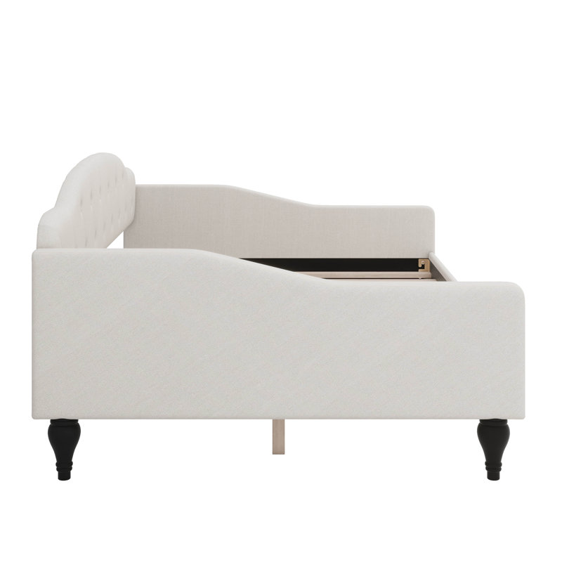 A Full-Size Upholstered Daybed With Tufted Detailing
