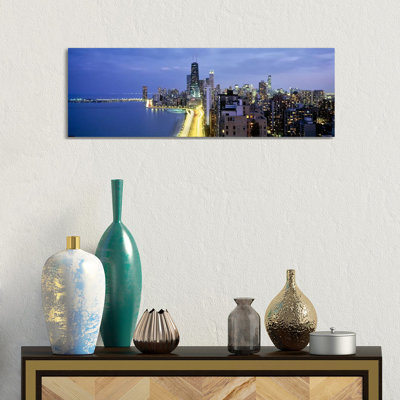 Skyscrapers Lit Up At The Waterfront, Lake Shore Drive, Chicago, Cook County, Illinois, USA by Panoramic Images - Wrapped Canvas Panoramic Print