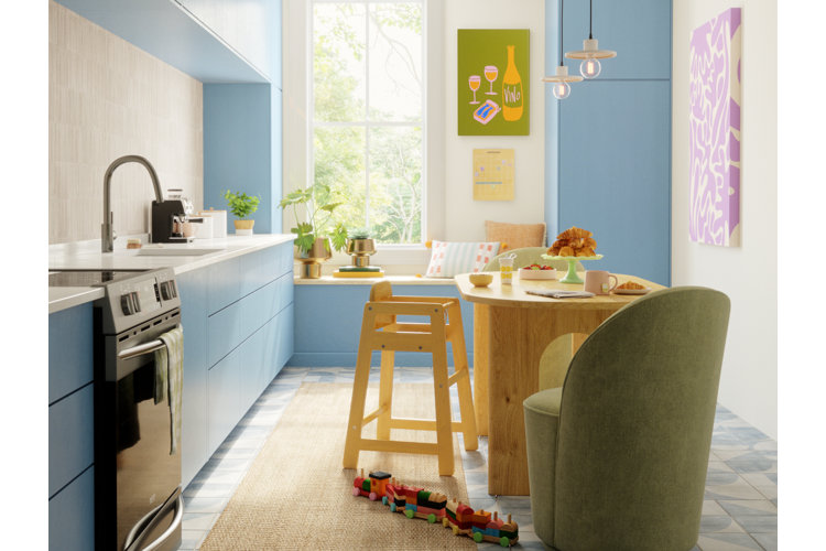 Bright modern kitchen with pendant island lighting, blue cabinets, wood dining table, and cozy breakfast nook seating