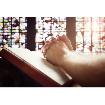 Praying Hands On A Holy Bible by BrianAJackson - Wrapped Canvas Print