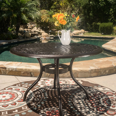 Table de salle à manger d'extérieur ronde de 48 pouces fabriquée en fonte d'aluminium en bronze martelé, avec plateau de table, trou de parasol et pieds incurvés, pour un patio relaxant avec une finition bronze de 48 pouces et une cour douce