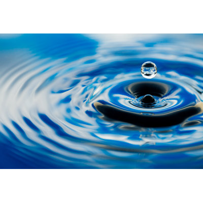Perfect Rain Drop Frozen in Mid Air Above Water Surface by Wundervisuals
