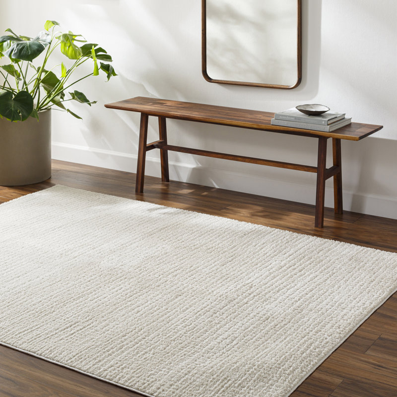 Arny Solid Color Machine Woven Polyester Area Rug in Cream