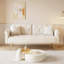 Un canapé-lit de 69,7 pouces de long recouvert de velours beige, avec une garniture cloutée et un coussin décoratif assorti-129455677