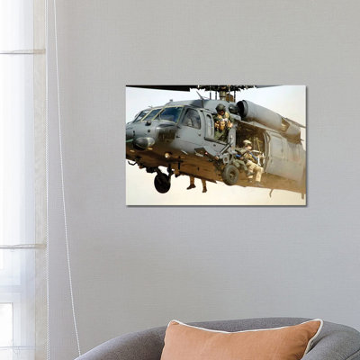 Pararescuemen Aboard A Helicopter Prepare For Landing - Wrapped Canvas Print