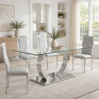 Table de salle à manger en verre transparent - un mélange parfait de durabilité et d'élégance. Plateau de table en verre trempé transparent, pieds de table en acier inoxydable argentés.