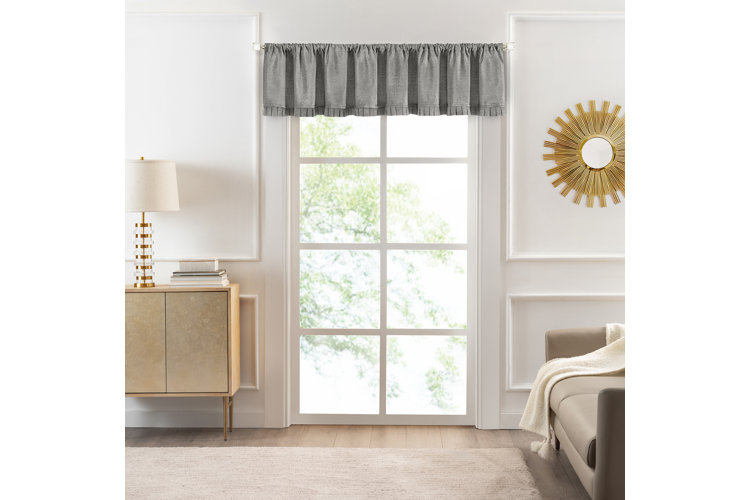 living room with large window featuring a gray valance