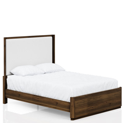 Grand lit en noyer avec tête de lit tapissier et support pour un sommeil confortable dans une chambre élégante
