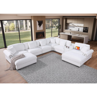 Grand canapé d'angle en tissu réversible avec deux repose-pieds, console de rangement avec porte-gobelets et ports de chargement