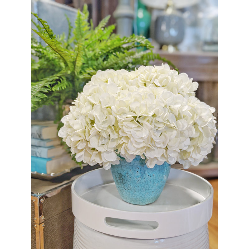 White Hydrangeas in Teal Ceramic Vase