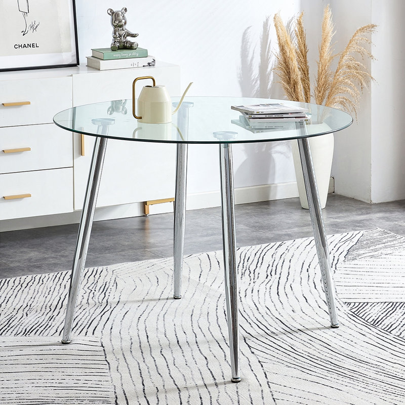 Table de salle à manger ronde moderne en verre trempé avec pieds en métal argenté pour espaces compacts, design clair et élégant