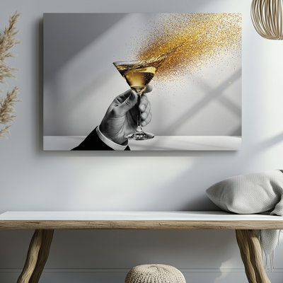 Canvas A Dynamic Composition Featuring A Hand Elegantly Holding A Martini Wall Art Glass With A Splash Of Golden Liquid Erupting From Canvas Wall Art