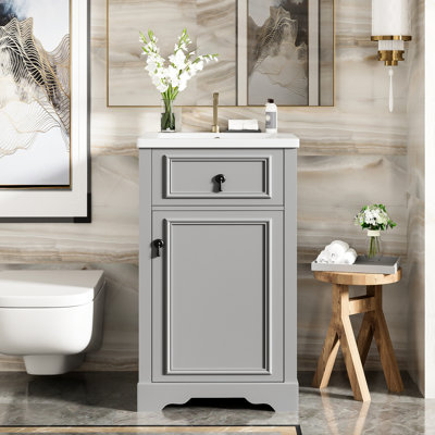 Meuble-lavabo de 20 pouces avec lavabo en céramique, porte à fermeture en douceur et dossier ouvert pour une petite installation.