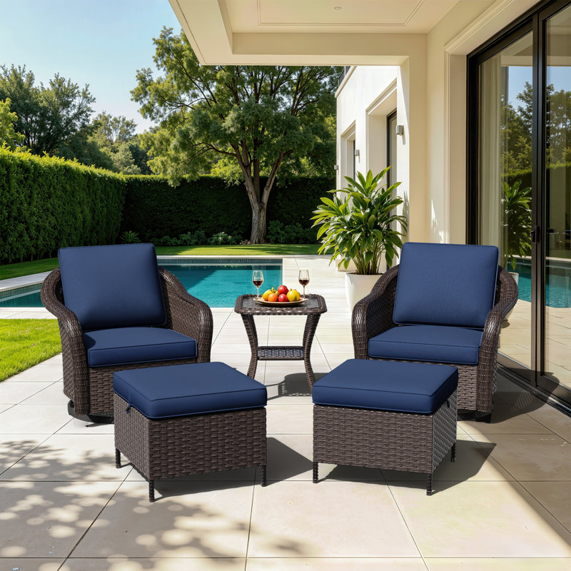 Ensemble de patio extérieur 5 pièces Alderwood en résine tressée PE, comprenant des chaises pivotantes, des poufs et une table d'appoint avec coussins bleus.