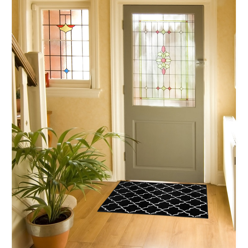 Tapis noir en polypropylène à motif floral Spiceland