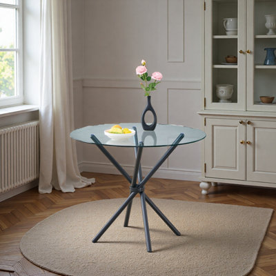 Une table ronde circulaire en verre trempé transparent d'un diamètre de 36,6 pouces, avec des pieds en métal froncés en forme d'anneau. Le verre du bureau a une épaisseur de 0,3 pouce.
