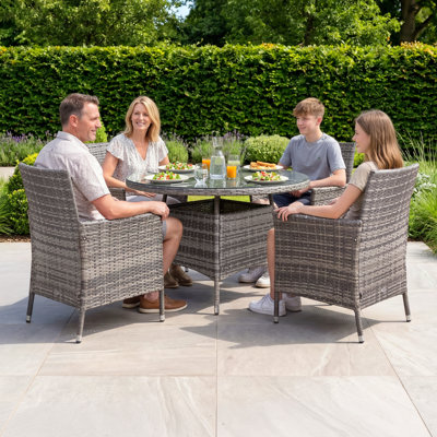 Nohemi 4 - Person Patio Dining Set Round Table with Cushions Included