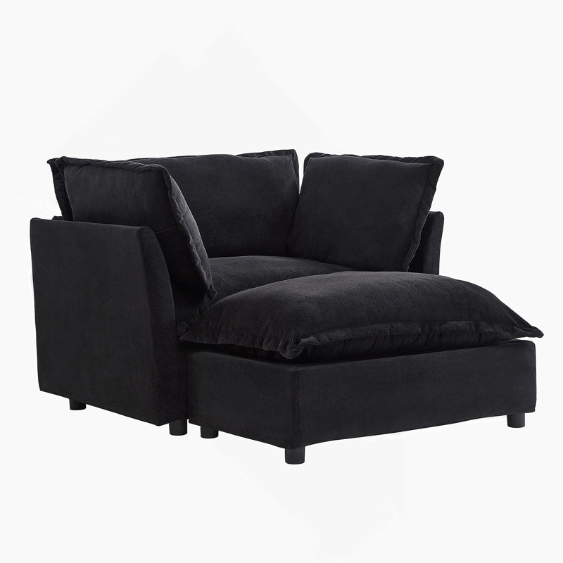 Fauteuil moderne avec repose-pieds mobile, siège large, accoudoirs courbés et coussins moelleux pour un salon et une chambre à coucher confortables