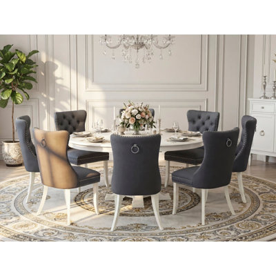 9-Pc Dining Table Set consists of a Modern Table with a round tabletop and 8 Platinum Grey Polyester Chairs with Button Tufted, Linen White