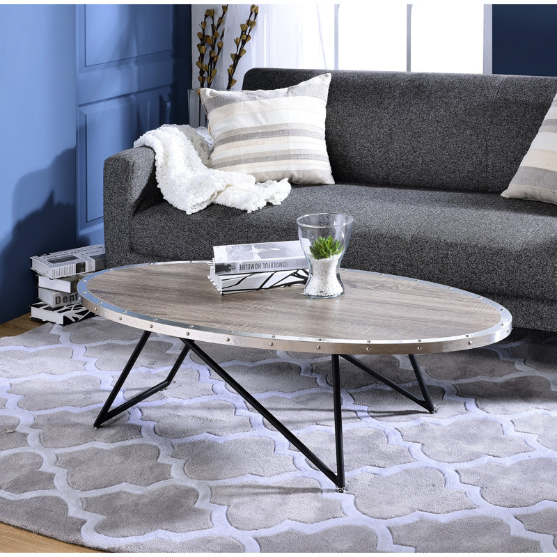 Table basse ovale en chêne gris vieilli avec plateau en bois synthétique, largeur 117 cm, poids 9 kg, piètement en métal, supportant jusqu'à 32 kg.