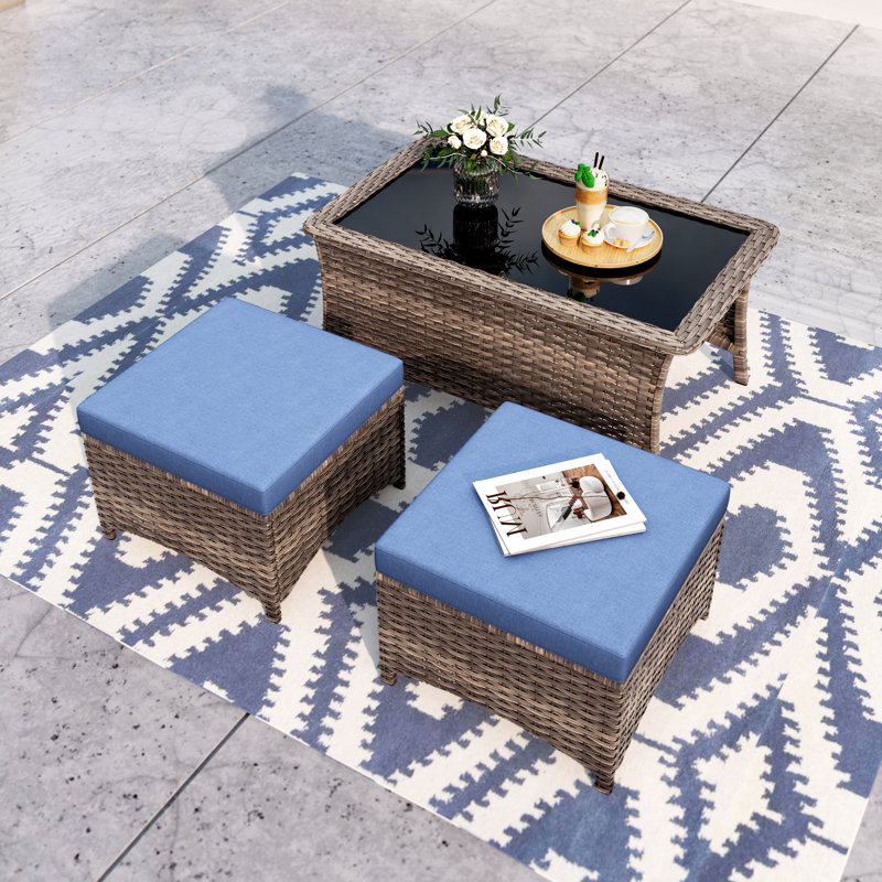 An Outdoor Patio Coffee Table & Two Ottomans