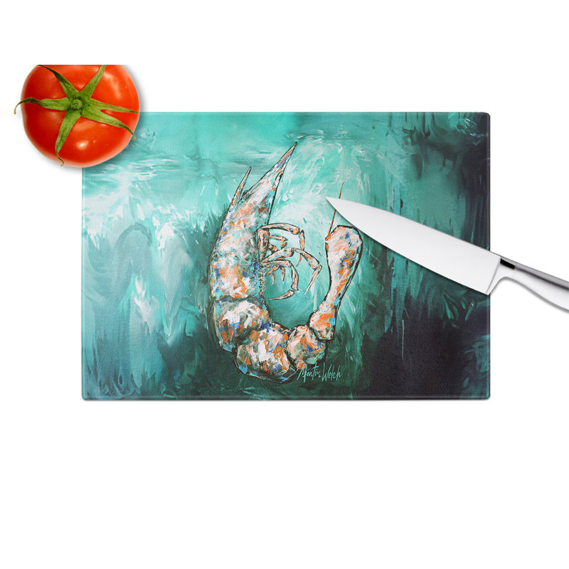 Une planche à découper en verre à crevettes bleues