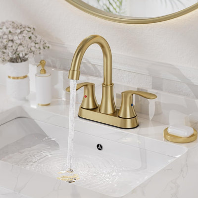Robinet de salle de bain Mosson à deux poignées en or brossé, avec bec courbé et bonde escamotable en plastique