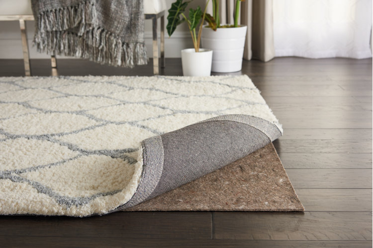 plush area rug folded up at the corner with a felt rug pad underneath