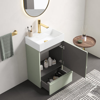20-Inch Striped Light Green Freestanding Bathroom Vanity With Integrated White Ceramic Sink And Smart Storage Design.