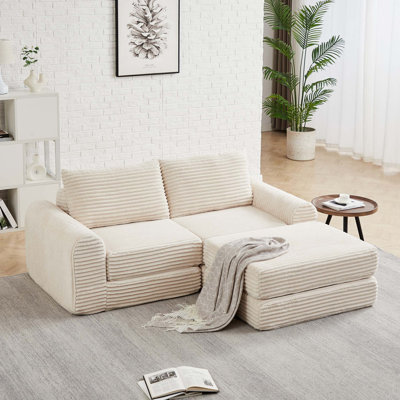 Canapé-lit modulaire minimaliste en velours côtelé avec dossier incurvé et coussins décoratifs