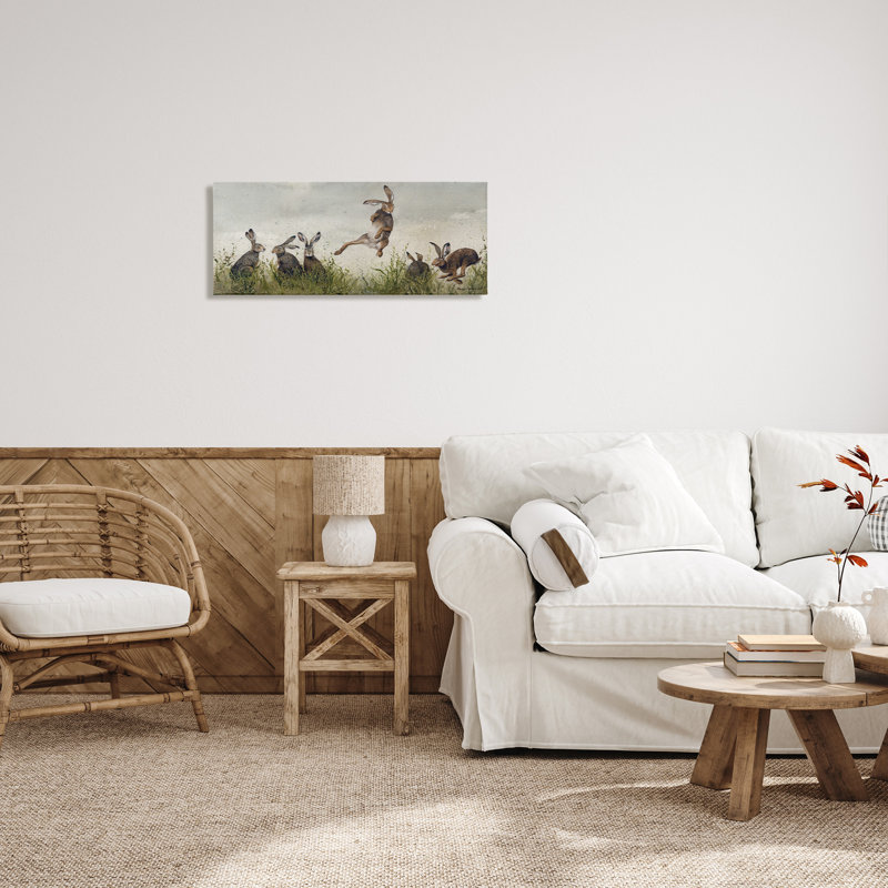Jumping Hares in Wild Canvas Wall Art by Maggie Vandewalle, 13" H x 30" W