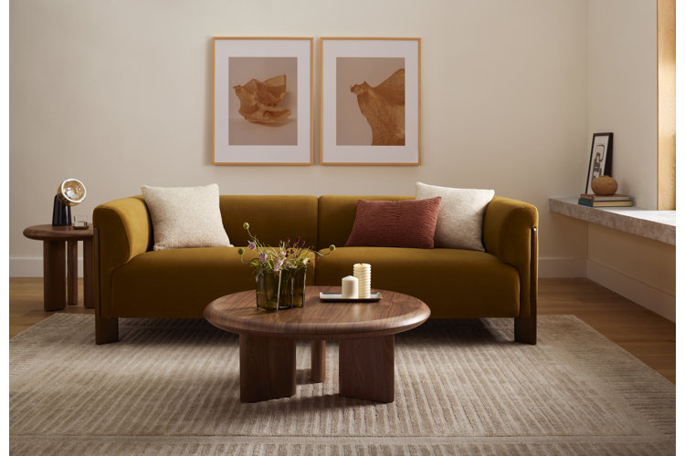 how long do sofas last mid-century modern living room with beige and pink wall art a yellow velvet sofa a round wood table and matching side table and a modern table lamp
