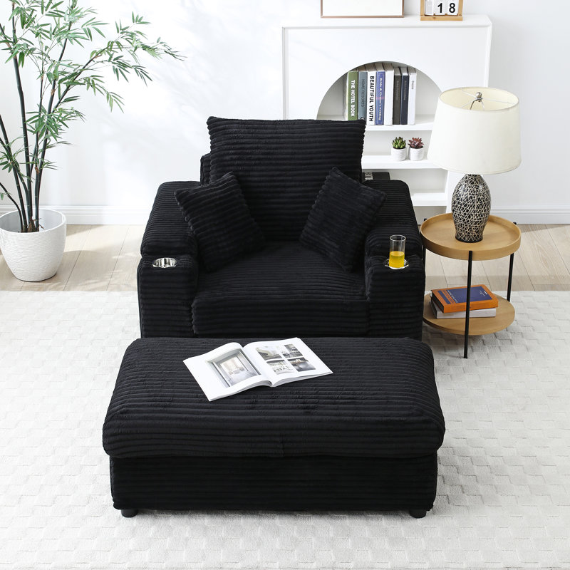 Fauteuil noir surdimensionné avec fauteuil d'appoint