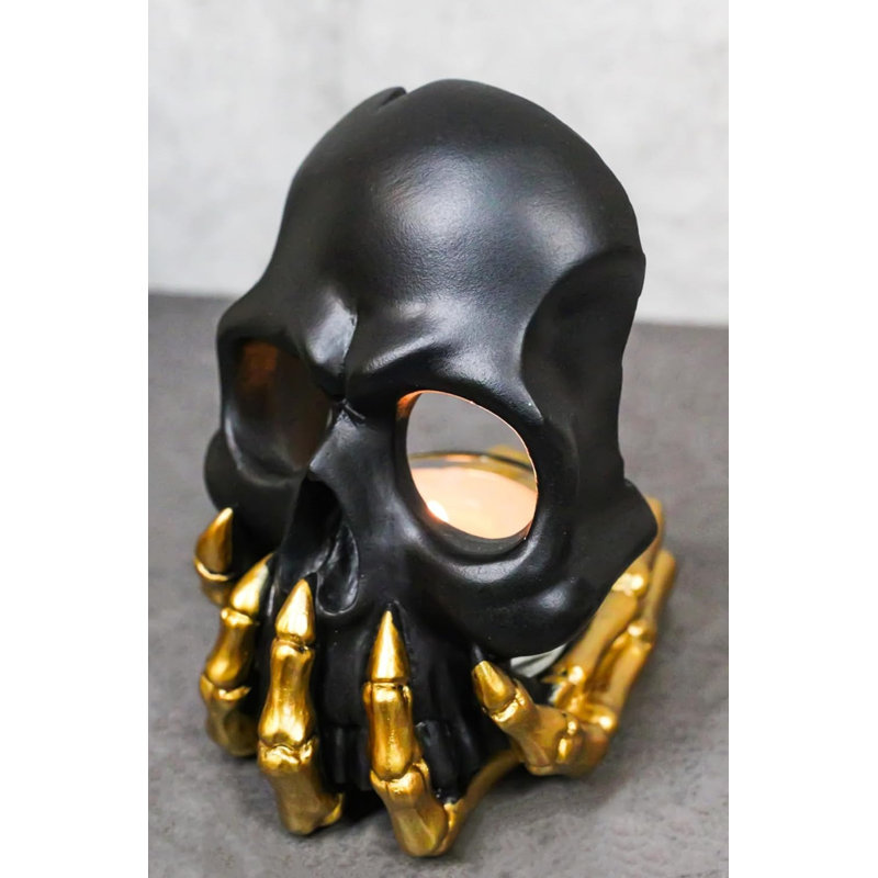 Porte-bougie noir avec masque à tête de mort fantôme noir sur squelette doré