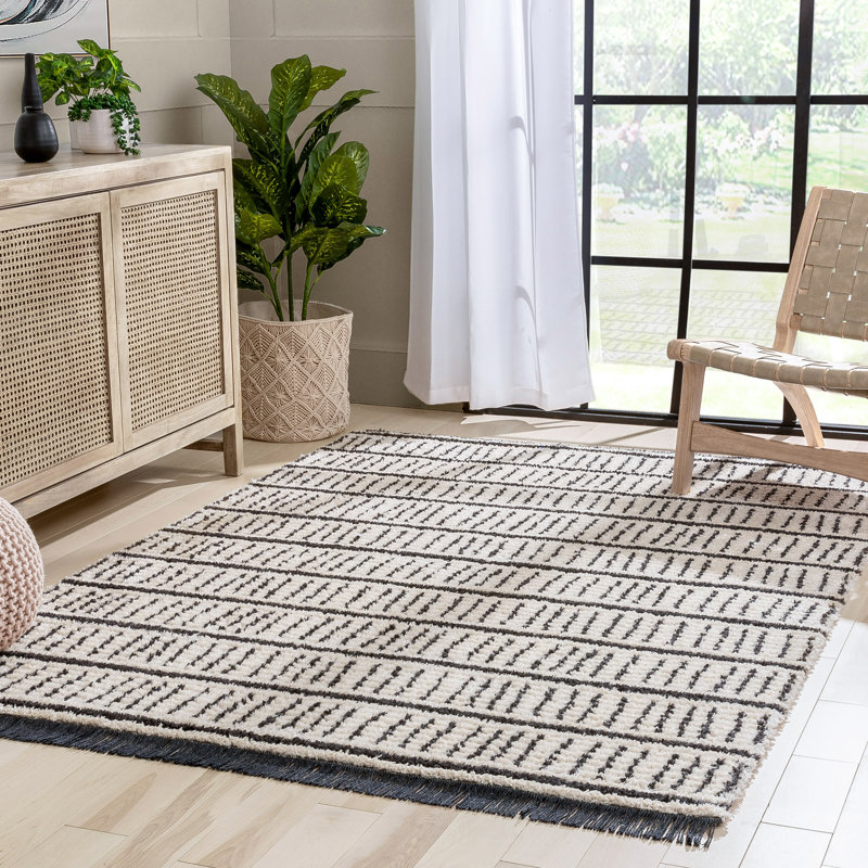 Ivory and Black Geometric Synthetic 4' x 6' Area Rug