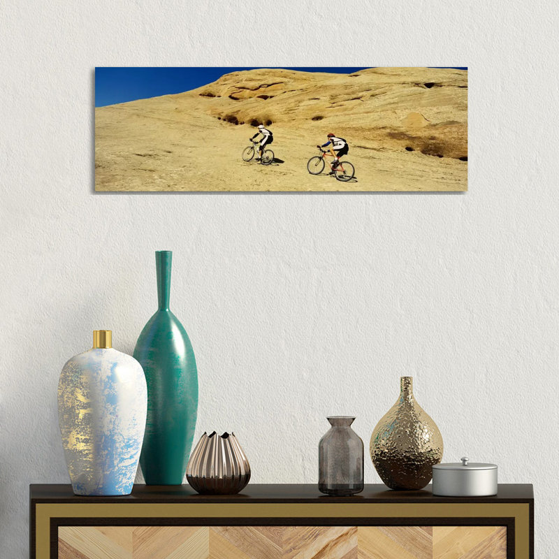 Side Profile Of Two Men Mountain Bilking On Rocks, Slickrock Trail, Moab, Utah, USA by Panoramic Images - Wrapped Canvas Panoramic Print