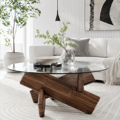 Table basse ronde artistique en forme de croix avec plateau en verre trempé gris fumé et piètement en MDF à motif noyer