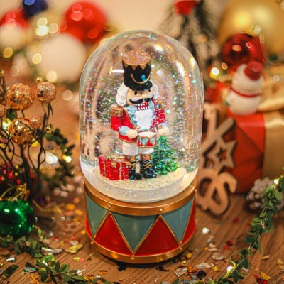 Boule à neige de Noël - figurine de soldat casse-noisette festif avec base en forme de tambour, chute de neige et fonction musicale pour décoration de Noël