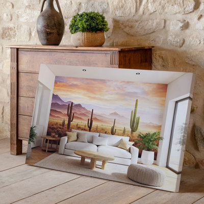 Toile, un salon moderne avec une grande peinture murale sur le thème du désert, représentant des cactus et des montagnes au coucher du soleil