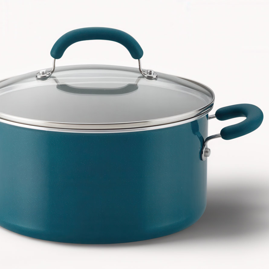 Close-up of a teal stock pot with a glass lid.