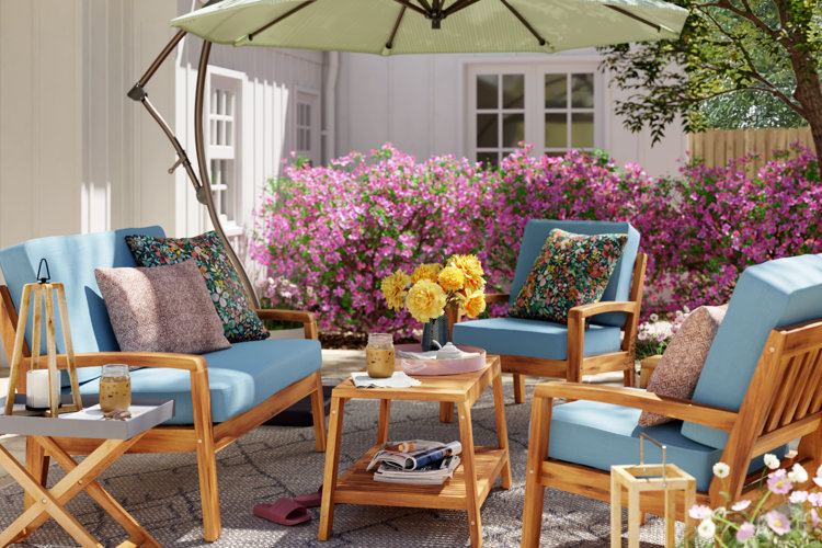 teak patio conversation set with bright blue cushions