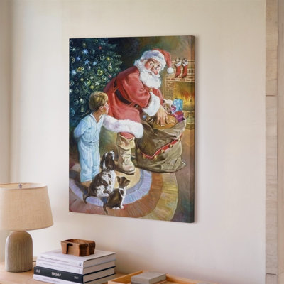 Canvas A Cozy Christmas Scene Featuring Santa Claus In A Traditional Wall Art Red Suit With White Fur Trim Kneeling Beside A Large Canvas Wall Art