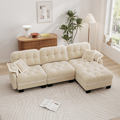 Chenille Cloud L-Shaped Sofa, complete with an ottoman and throw pillows, featuring quilted tufted cushions with pom-pom trim and an ergonomic design. This deep-seated sofa is ideal for living rooms, offices, and apartments.