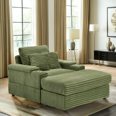 Canapé simple en velours côtelé vert avec un oreiller